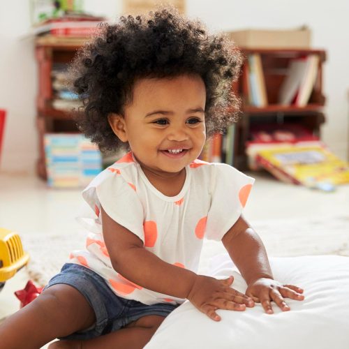 happy-baby-girl-playing-with-toys-playroom